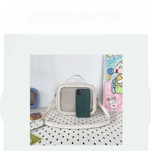 Compact white Ita bag with clear window and phone inside for size comparison