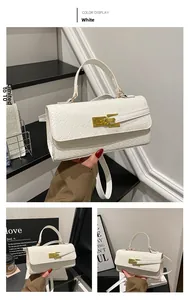 Detailed view of the white woven texture and golden clasp on this stylish square handbag
