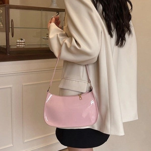 Pink patent leather baguette shoulder bag with glossy mirror finish and minimalist design