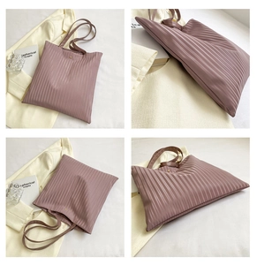 Detail view of the elegant dusty pink tote bag with soft pleated texture and slim straps