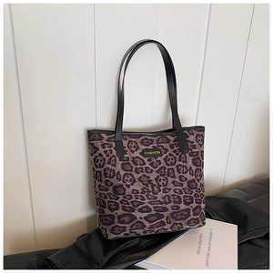 Macro shot of Leopard print tote bag showing the texture and the Fashion leather patch logo