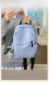 Close-up of a light blue nylon crossbody bag with sneaker charm and Liangku Fashion label