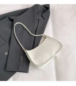 Minimalist white PU leather shoulder bag styled with a dark grey business blazer