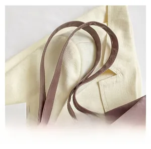 Detailed close-up of handle stitching on a dusty pink faux leather minimalist tote bag