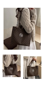 Macro view of brown monogram tote bag with gold M-logo and metal chain strap details