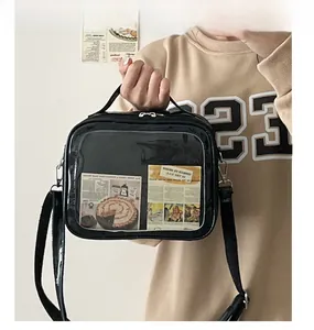 Detail of black ita bag with transparent window and decorative vintage cards for display