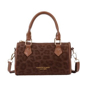 Fashionable leopard print velvet boston bag with brown leather handles and gold hardware
