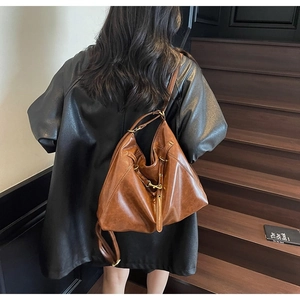 Brown vintage faux leather tote backpack shown from behind on a model during commute