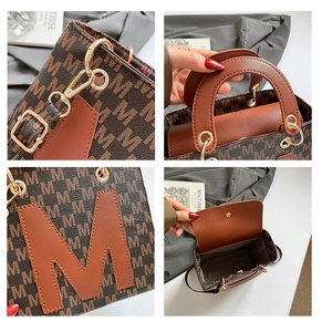 Detail of vintage brown tote bag with M-pattern, gold hardware, and interior compartment