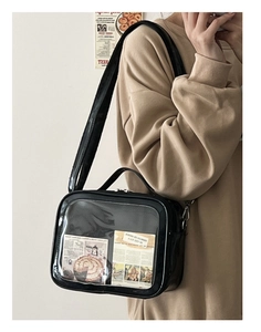Detail of black ita bag with clear display window showing decorative art cards