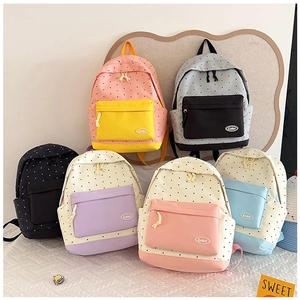 Detailed display of colorful polka dot canvas backpacks in six stylish color variations