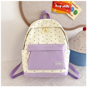 Close-up of the durable purple canvas pocket with Lolo! logo on polka dot backpack