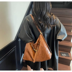 Maillard vintage brown PU leather tote bag shown from back on a model on wooden stairs