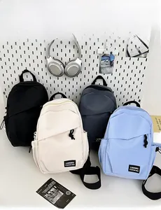 Detail view showing compact crossbody backpacks in various colors with waterproof fabric