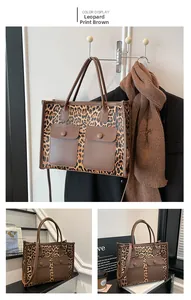 Detail shot of leopard print tote bag with brown faux leather trim and dual front pockets
