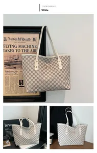 Detail of white tote bag featuring M-letter pattern and golden bow metal buckle