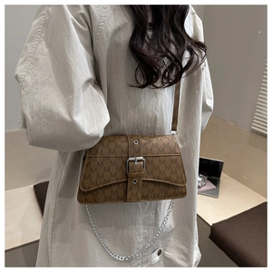 Brown faux leather crossbody bag with vintage M-pattern and silver buckle detail