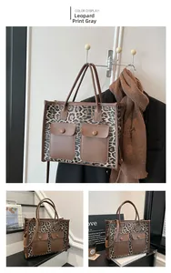 Detail view of leopard print tote bag with brown trim and dual front pockets