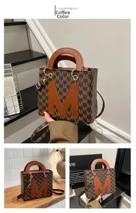 Detailed macro view of the coffee brown tote bag with all-over M monogram print texture