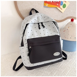 Close-up of stylish two-tone canvas backpack with black polka dots and Lolo! logo