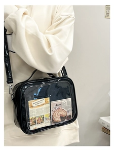 Detail of glossy black ita bag with clear window showing retro decorative cards