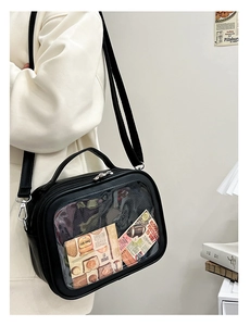 Detail of black ita bag with transparent window and adjustable crossbody strap