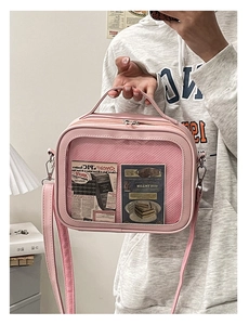 Pink Ita bag with transparent window and shoulder strap shown in a real-life mirror selfie