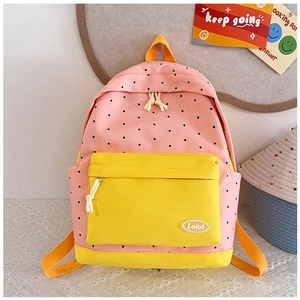 Detailed view of pink and yellow polka dot backpack with a front zipper pocket