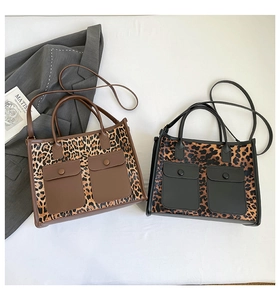 Detail view of leopard print tote bags with front pockets and top handles for women
