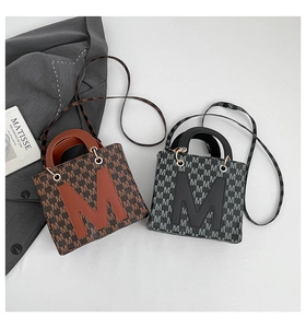 Flat lay of vintage mini tote bags with letter M print in brown and black color