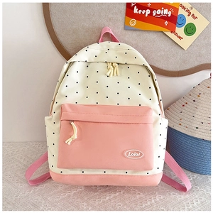 Close-up of pink and white polka dot canvas backpack with a Lolo oval patch logo