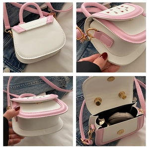 Macro view of the pink and white cherry print handbag showing internal storage capacity