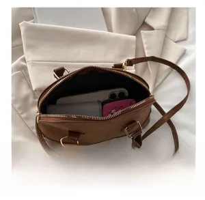 Top view of brown Boston bag showing large interior capacity with matte texture finish
