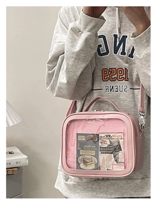 Detailed view of pink heart-shaped transparent window on a small PU leather ita bag