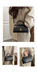 Detail view of black gloss crossbody bag featuring elegant gold clasp and versatile straps