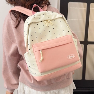 Polka dot pattern student backpack in pink and off-white colors with star accents