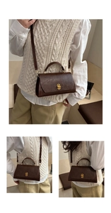 Detail view of vintage dark brown faux leather crossbody bag with gold clasp and strap