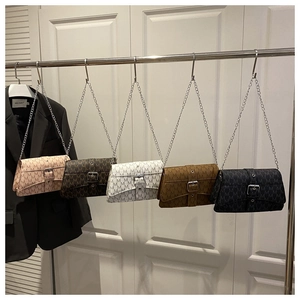 Detail view of five stylish chain shoulder bags with M-letter pattern in various colors