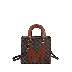 Classic dark brown vintage tote bag with letter M print and leather handles