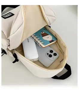 Interior view showing capacity for smartphone, power bank and notebook in small crossbody bag