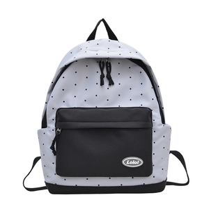 Minimalist white polka dot backpack with black front pocket and durable fabric