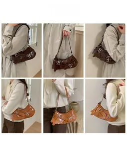 Detail of vintage style PU leather shoulder bag with multiple metal buckles in two colors