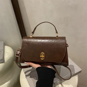 Vintage brown oil wax leather crossbody bag with gold metal buckle and handle