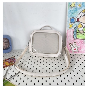 Detailed view of a white Ita bag with transparent window for DIY anime display
