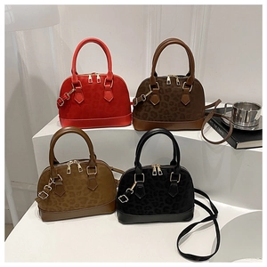 Four colors of stylish leopard print shells handbags displayed on white stairs