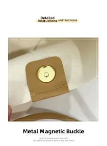 Detail of golden magnetic clasp on cream canvas tote bag with brown leather trim