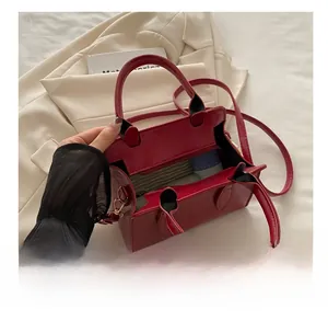 Detailed interior of red leather handbag showing storage space for daily essentials