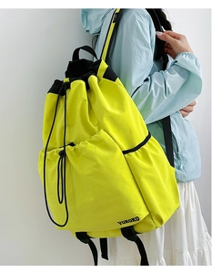 Side view of lightweight fluorescent yellow drawstring sports backpack with side pockets