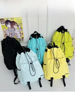 Detail showing various colors of lightweight drawstring backpacks with side mesh pockets