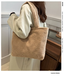 Detail of soft khaki sherpa fleece tote bag with wide shoulder strap on a model